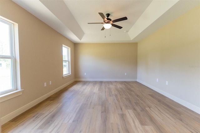 45 Pecan Course Loop, Ocala, FL 34472 - unfurnished room with a tray ceiling, a ceiling fan, and light wood-style flooring