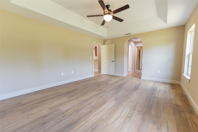 45 Pecan Course Loop, Ocala, FL 34472 - spare room featuring a raised ceiling, arched walkways, a ceiling fan, and light wood-style floors