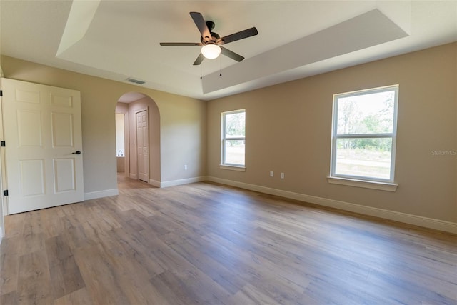 45 Pecan Course Loop, Ocala, FL 34472 - spare room featuring a tray ceiling, arched walkways, wood finished floors, and a ceiling fan