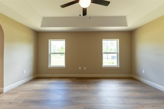 45 Pecan Course Loop, Ocala, FL 34472 - unfurnished room featuring a raised ceiling, arched walkways, light wood-type flooring, and ceiling fan