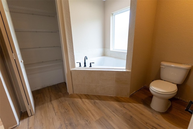 45 Pecan Course Loop, Ocala, FL 34472 - bathroom featuring a garden tub, wood finished floors, and a walk in closet
