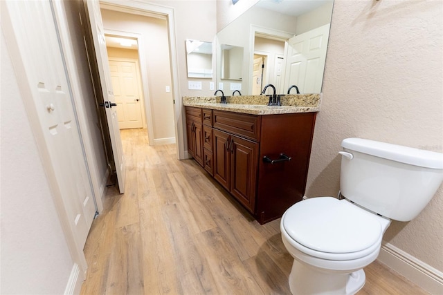 45 Pecan Course Loop, Ocala, FL 34472 - bathroom featuring wood finished floors, double vanity, and a textured wall