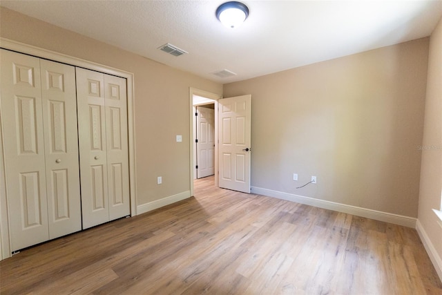 45 Pecan Course Loop, Ocala, FL 34472 - unfurnished bedroom with light wood-style flooring and a closet
