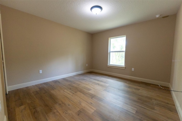 45 Pecan Course Loop, Ocala, FL 34472 - unfurnished room featuring wood finished floors and a textured ceiling