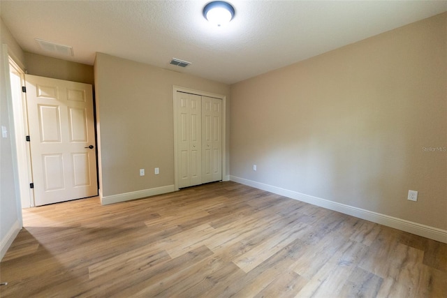 45 Pecan Course Loop, Ocala, FL 34472 - unfurnished bedroom featuring light wood-type flooring and a closet