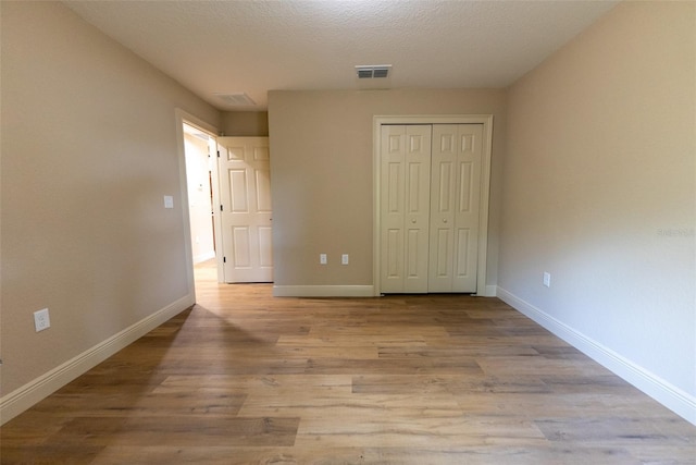45 Pecan Course Loop, Ocala, FL 34472 - unfurnished bedroom featuring a closet and wood finished floors