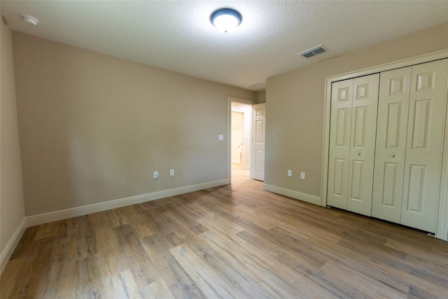 45 Pecan Course Loop, Ocala, FL 34472 - unfurnished bedroom with wood finished floors and a closet