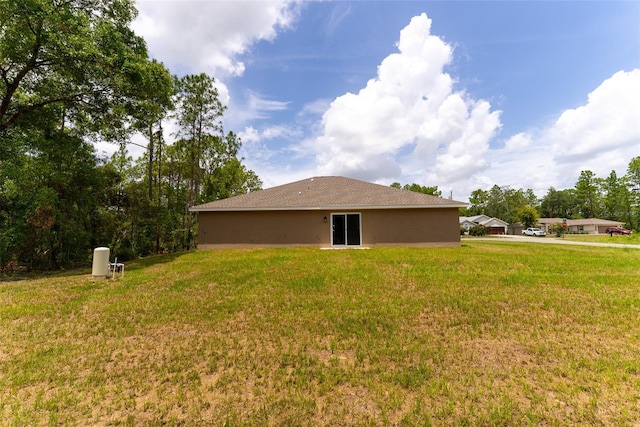 45 Pecan Course Loop, Ocala, FL 34472 - view of home's exterior with stucco siding and a lawn