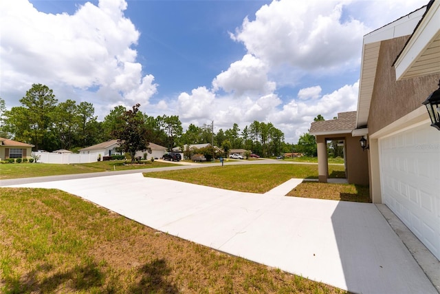 45 Pecan Course Loop, Ocala, FL 34472 - view of grassy yard with a garage, driveway, and a residential view