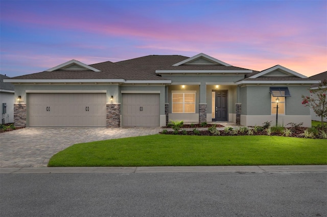 10880 SW 101st Loop, Ocala, FL 34481 - view of front of property featuring a garage, decorative driveway, a front yard, stucco siding, and a shingled roof