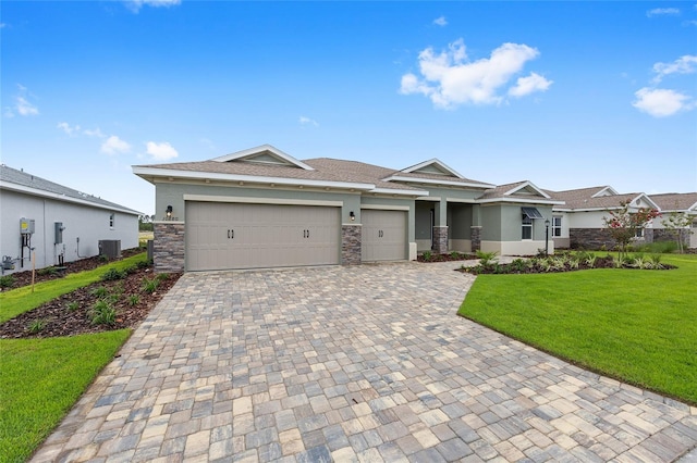 10880 SW 101st Loop, Ocala, FL 34481 - view of front of property featuring decorative driveway, a front lawn, an attached garage, stone siding, and stucco siding