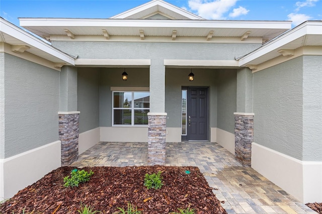 10880 SW 101st Loop, Ocala, FL 34481 - doorway to property featuring stucco siding, stone siding, and covered porch