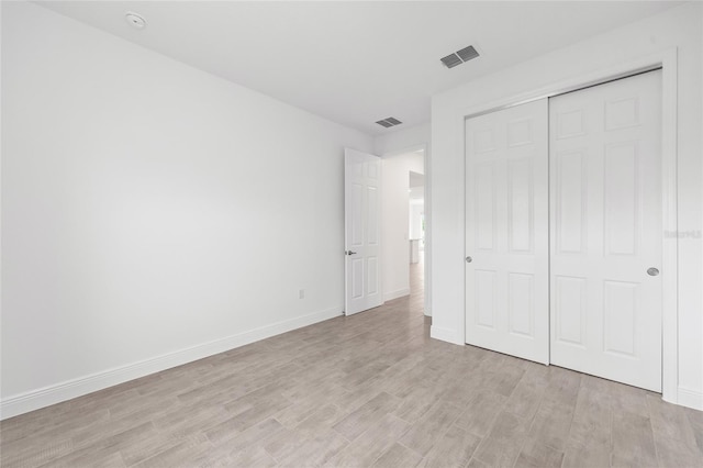 10880 SW 101st Loop, Ocala, FL 34481 - unfurnished bedroom featuring light wood-style floors and a closet