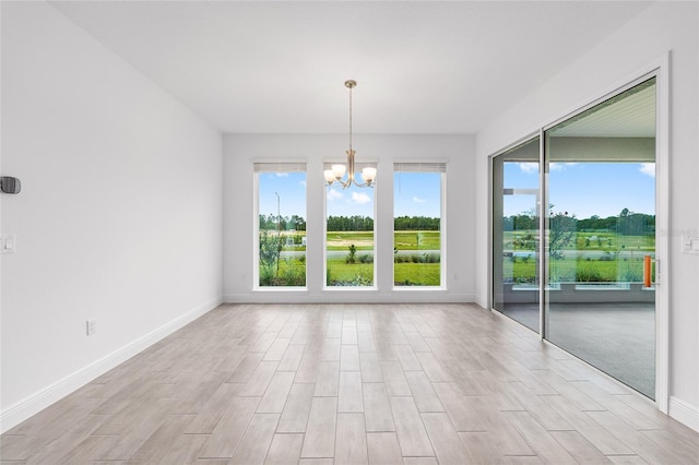 10880 SW 101st Loop, Ocala, FL 34481 - spare room with a chandelier and light wood finished floors