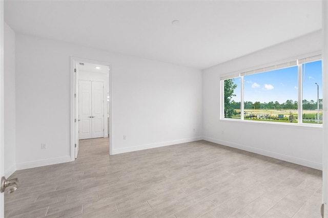 10880 SW 101st Loop, Ocala, FL 34481 - spare room featuring baseboards and light wood-style floors