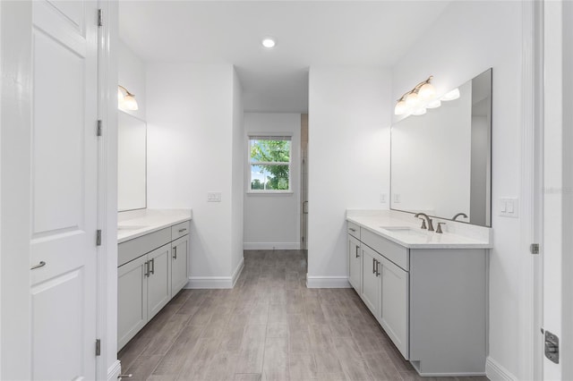 10880 SW 101st Loop, Ocala, FL 34481 - bathroom featuring two vanities, wood finished floors, and recessed lighting