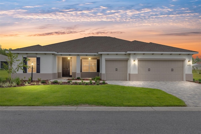 10833 SW 101st Loop, Ocala, FL 34481 - view of front facade with stucco siding, a garage, a front yard, and decorative driveway