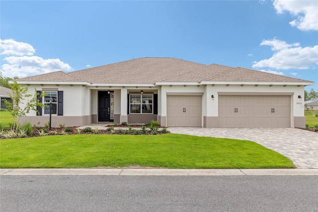 10833 SW 101st Loop, Ocala, FL 34481 - ranch-style home featuring stucco siding, a front lawn, an attached garage, and decorative driveway
