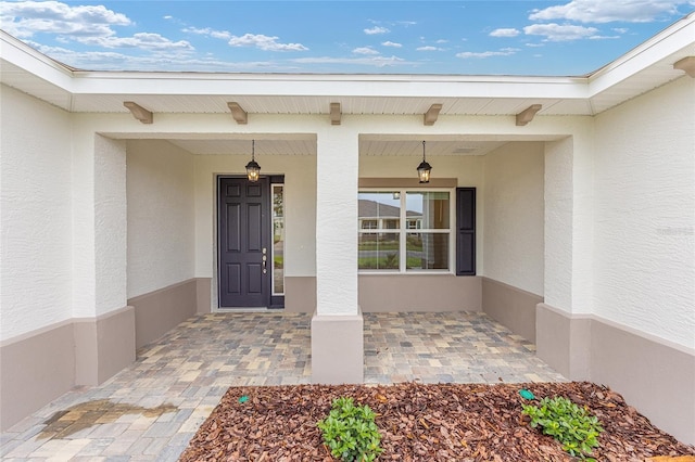 10833 SW 101st Loop, Ocala, FL 34481 - view of exterior entry with stucco siding and covered porch