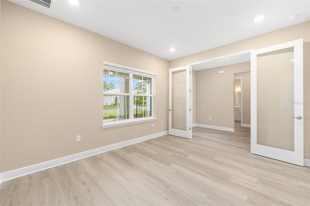 10833 SW 101st Loop, Ocala, FL 34481 - unfurnished bedroom featuring light wood-type flooring, french doors, and recessed lighting