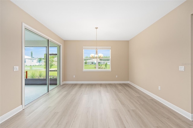 10833 SW 101st Loop, Ocala, FL 34481 - unfurnished room with a chandelier and light wood-type flooring