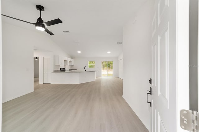 1581 SW Paradise Heights Rd, Dunnellon, FL 34431 - unfurnished living room with a ceiling fan, vaulted ceiling, light wood-type flooring, and recessed lighting
