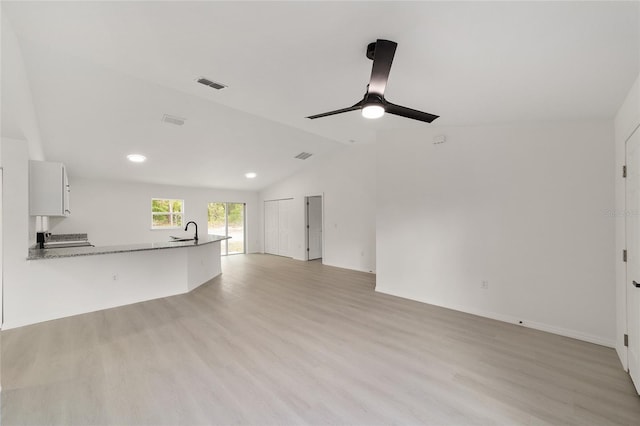 1581 SW Paradise Heights Rd, Dunnellon, FL 34431 - unfurnished living room with lofted ceiling, light wood-type flooring, ceiling fan, and recessed lighting