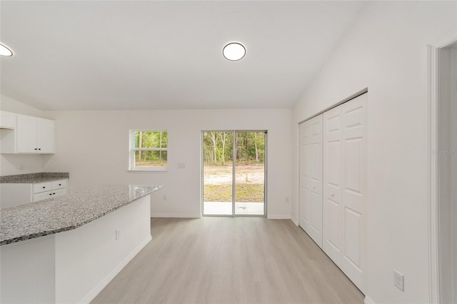 1581 SW Paradise Heights Rd, Dunnellon, FL 34431 - unfurnished dining area featuring light wood finished floors and vaulted ceiling