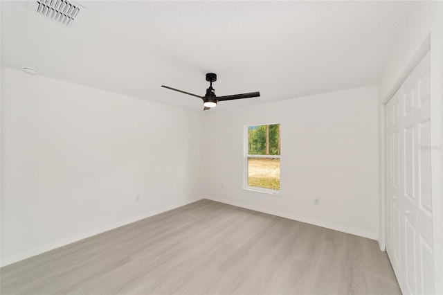 1581 SW Paradise Heights Rd, Dunnellon, FL 34431 - unfurnished bedroom with light wood-style flooring, a closet, and a ceiling fan