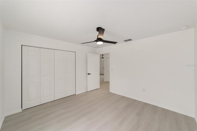 1581 SW Paradise Heights Rd, Dunnellon, FL 34431 - unfurnished bedroom featuring light wood-style floors, a closet, and a ceiling fan