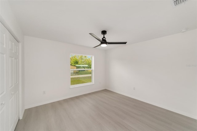 1581 SW Paradise Heights Rd, Dunnellon, FL 34431 - unfurnished bedroom with light wood-style flooring, a closet, and a ceiling fan