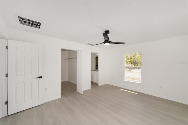 1581 SW Paradise Heights Rd, Dunnellon, FL 34431 - unfurnished bedroom with light wood-style floors, a spacious closet, and ceiling fan
