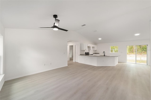 1581 SW Paradise Heights Rd, Dunnellon, FL 34431 - unfurnished living room with lofted ceiling, light wood-style flooring, ceiling fan, and recessed lighting