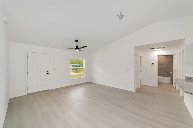 1581 SW Paradise Heights Rd, Dunnellon, FL 34431 - unfurnished living room with light wood finished floors, ceiling fan, and vaulted ceiling