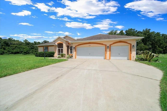 19583 SW 77th Loop, Dunnellon, FL 34432 - view of front of house with stucco siding, a front lawn, a garage, and concrete driveway