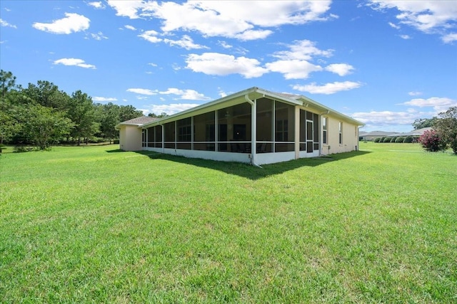 19583 SW 77th Loop, Dunnellon, FL 34432 - rear view of house featuring a sunroom and a lawn