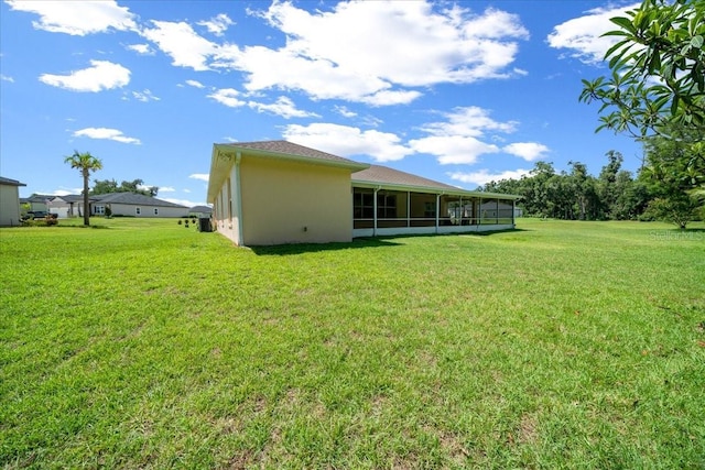 19583 SW 77th Loop, Dunnellon, FL 34432 - rear view of property with a sunroom and a yard