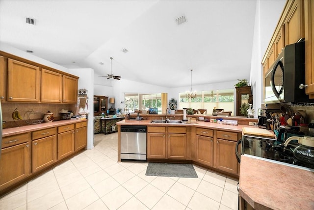 19583 SW 77th Loop, Dunnellon, FL 34432 - kitchen with black microwave, stainless steel dishwasher, brown cabinetry, and vaulted ceiling