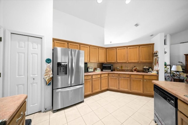 19583 SW 77th Loop, Dunnellon, FL 34432 - kitchen with appliances with stainless steel finishes, tasteful backsplash, light tile patterned floors, light countertops, and high vaulted ceiling