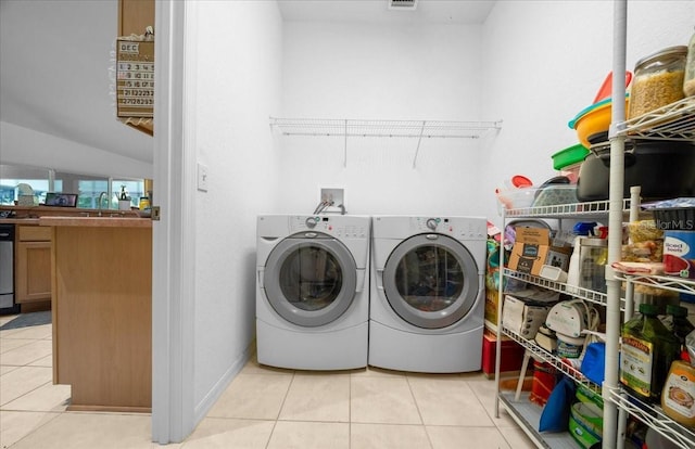 19583 SW 77th Loop, Dunnellon, FL 34432 - washroom with light tile patterned floors and separate washer and dryer