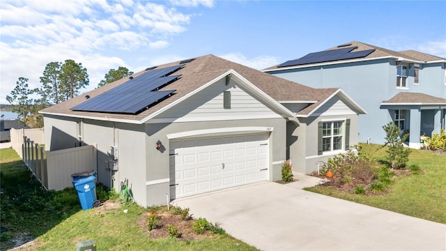 547 Tanaro Ln, Haines City, FL 33844 - traditional-style home featuring driveway, solar panels, an attached garage, roof with shingles, and stucco siding