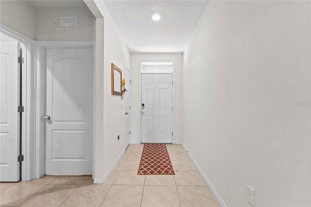 547 Tanaro Ln, Haines City, FL 33844 - doorway with light tile patterned floors and baseboards