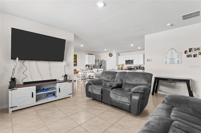 547 Tanaro Ln, Haines City, FL 33844 - living room featuring light tile patterned floors, recessed lighting, and a textured ceiling