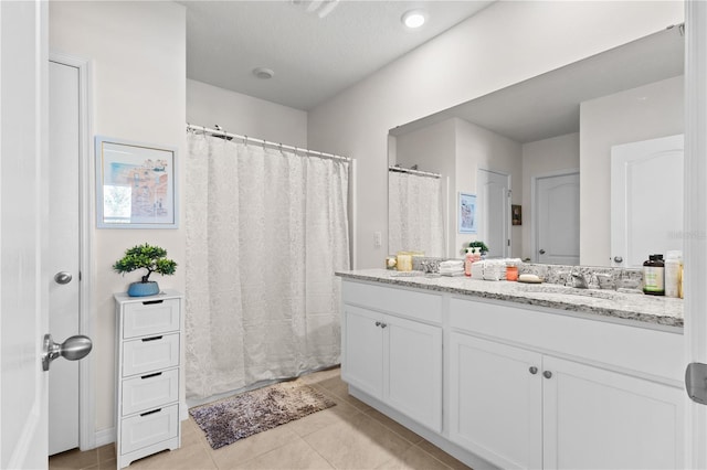 547 Tanaro Ln, Haines City, FL 33844 - bathroom with double vanity, tile patterned floors, and a shower with shower curtain