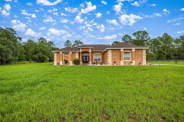 2587 W Angola Dr, Beverly Hills, FL 34465 - mediterranean / spanish house featuring stucco siding and a front lawn