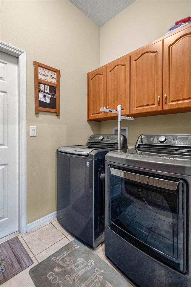 2587 W Angola Dr, Beverly Hills, FL 34465 - washroom featuring washing machine and clothes dryer, cabinet space, light tile patterned flooring, and a textured ceiling