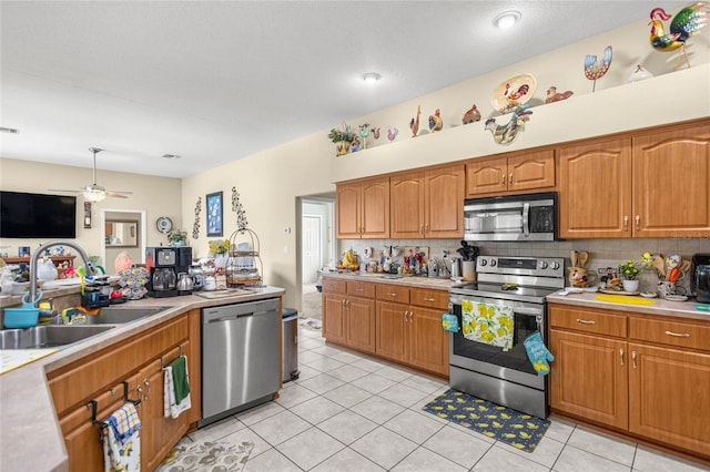 2587 W Angola Dr, Beverly Hills, FL 34465 - kitchen featuring appliances with stainless steel finishes, light countertops, a ceiling fan, backsplash, and brown cabinets