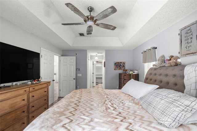 2685 W Apricot Dr, Beverly Hills, FL 34465 - bedroom featuring a raised ceiling, ceiling fan, and a textured ceiling