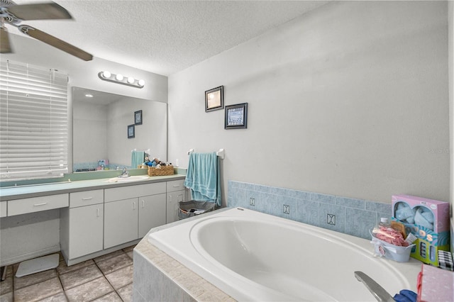 2685 W Apricot Dr, Beverly Hills, FL 34465 - bathroom with vanity, a ceiling fan, a bath, a textured ceiling, and tile patterned flooring