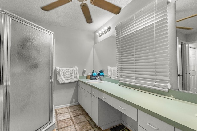 2685 W Apricot Dr, Beverly Hills, FL 34465 - bathroom featuring a ceiling fan, vanity, a shower stall, and a textured ceiling